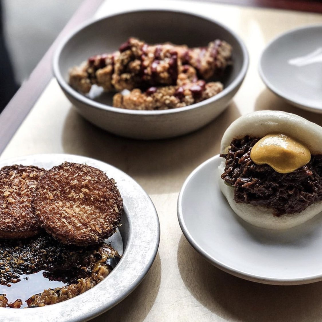 Dishes from bao such as aubergine dish and buns.
