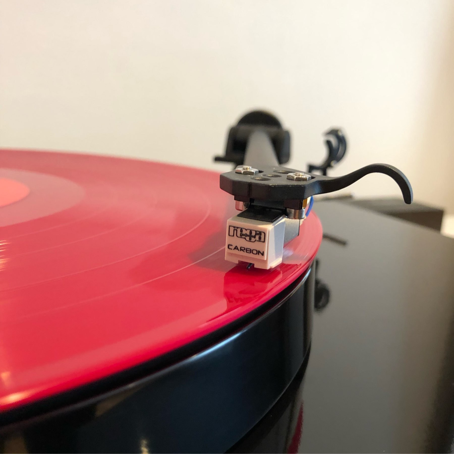 Rega Carbon needle on a pink record playing.
