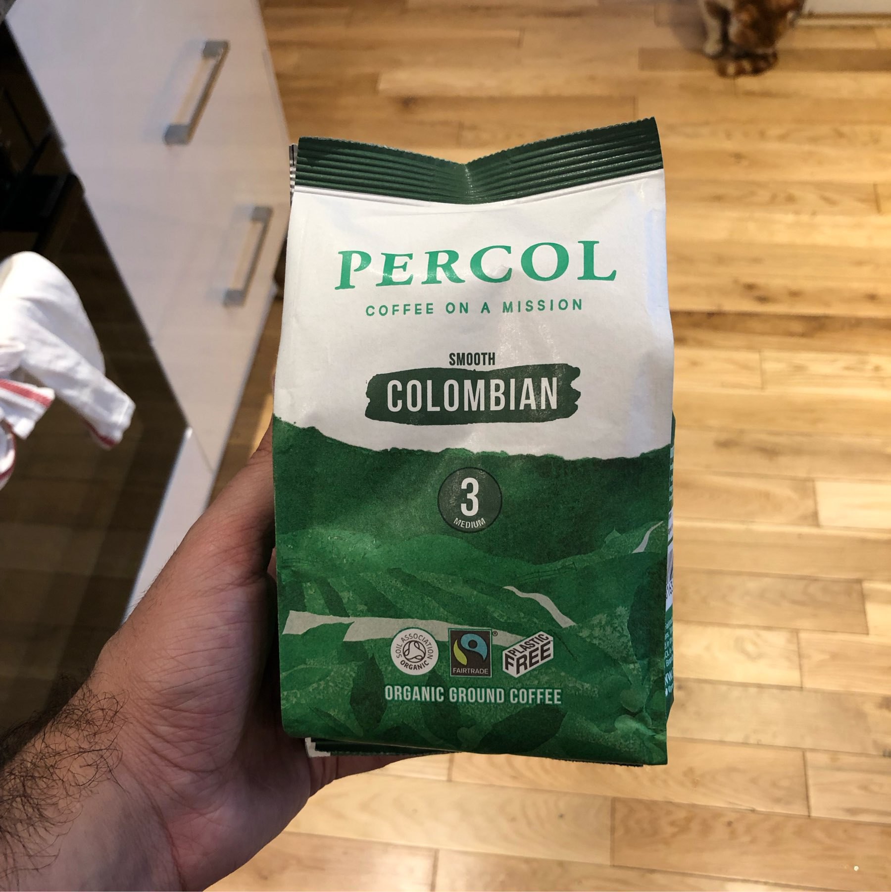 Green bag of Percol coffee with a note saying Plastic Free and Coffee on a mission