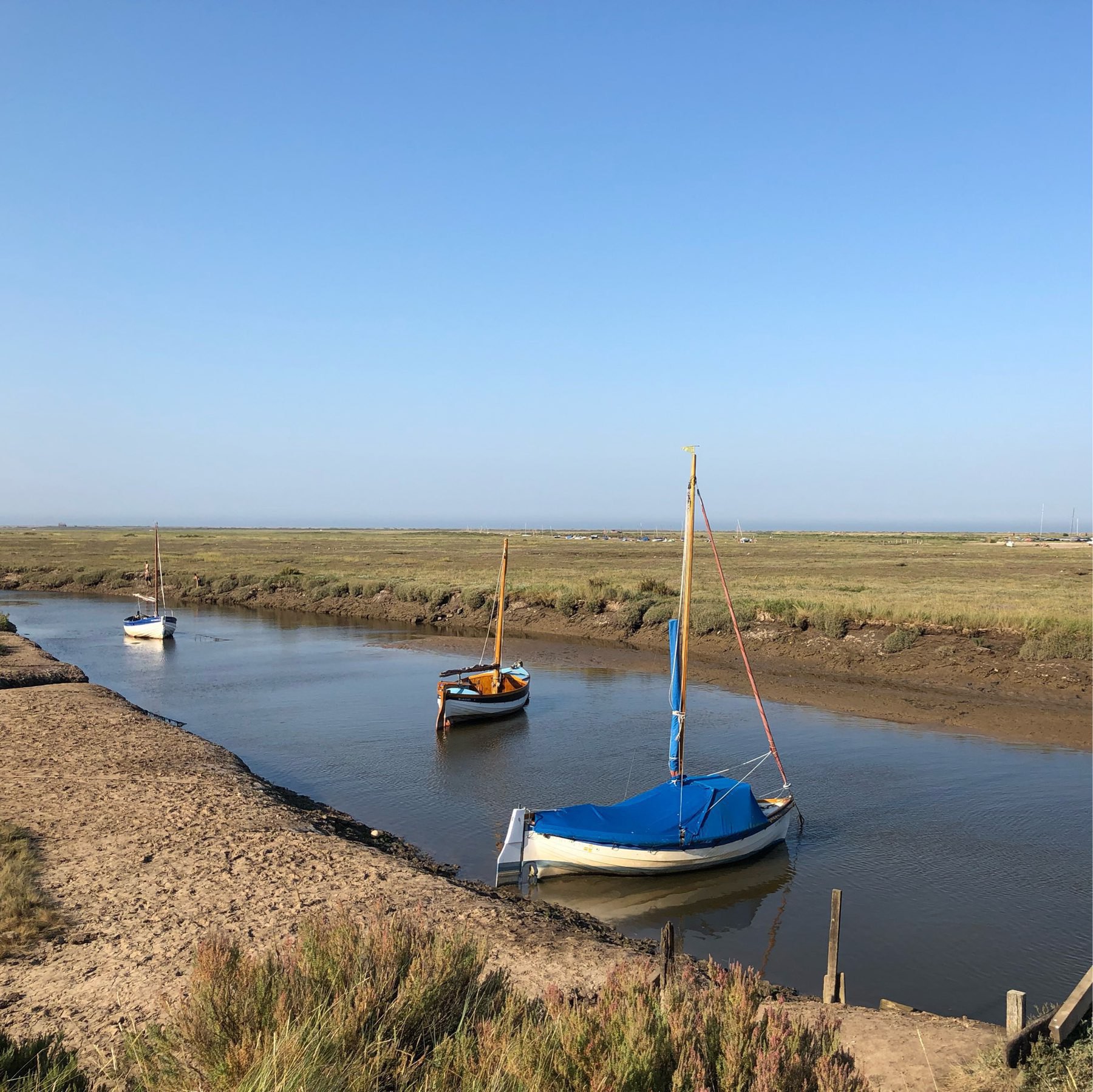 Tide is low and you can see the fields with the boats parked waiting to be taken away and sailed.